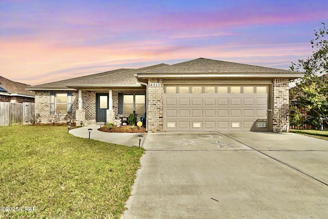 prairie-style home with a garage and a yard