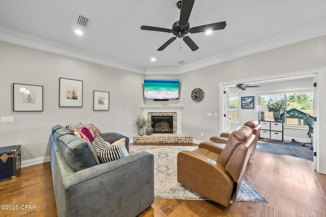 living room with ornamental molding and hardwood / wood-style flooring