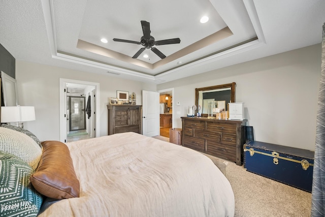 carpeted bedroom featuring a raised ceiling and ceiling fan