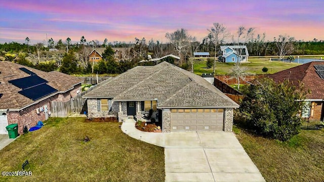 view of front of house featuring a garage and a yard