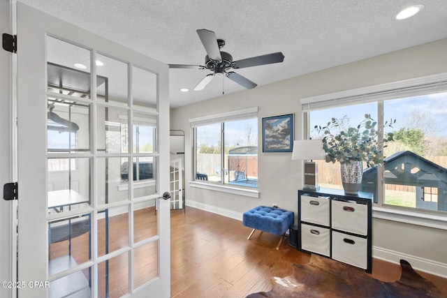 office space featuring hardwood / wood-style floors, french doors, ceiling fan, and a textured ceiling