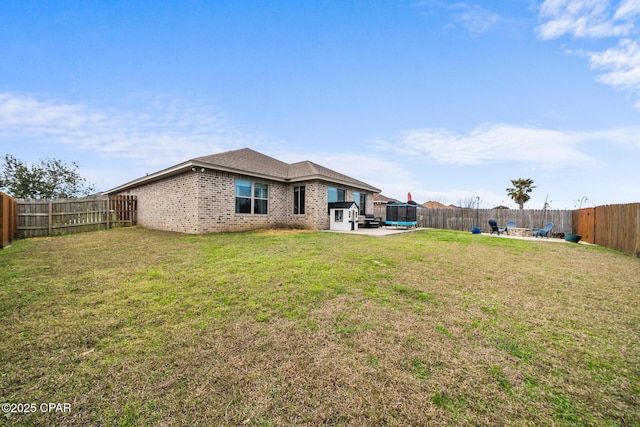 back of property featuring a patio and a lawn