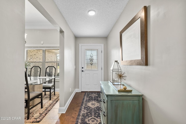 doorway with dark hardwood / wood-style floors and a textured ceiling