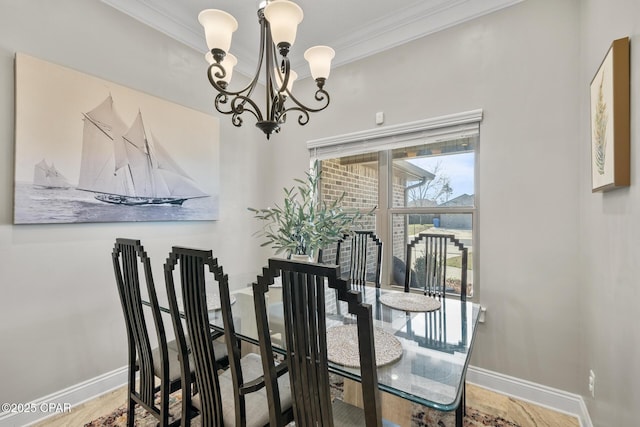 dining room with a chandelier and crown molding