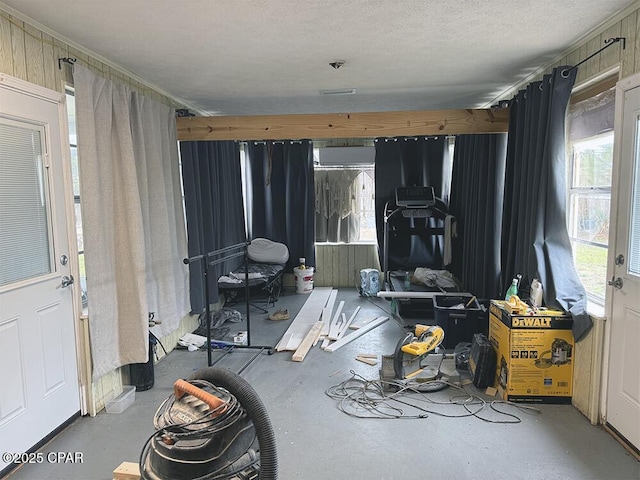 miscellaneous room featuring a textured ceiling and concrete floors