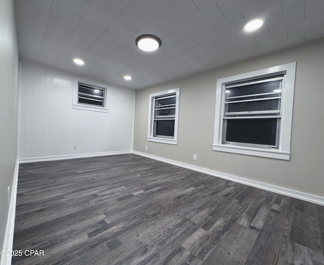 unfurnished room with dark hardwood / wood-style floors and built in shelves