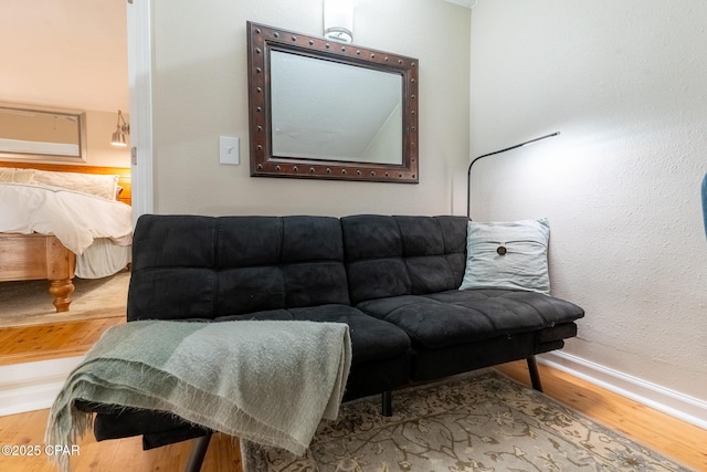 living room featuring wood finished floors and baseboards