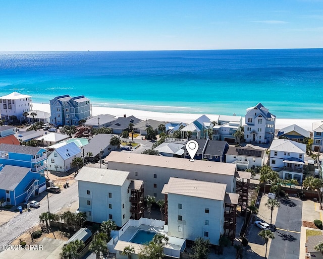 birds eye view of property with a beach view and a water view