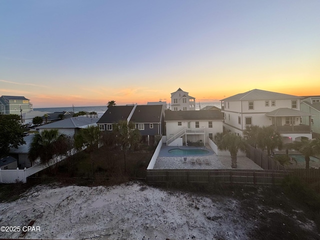 back of property featuring a fenced backyard and a residential view