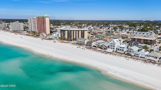 drone / aerial view with a view of city, a water view, and a beach view