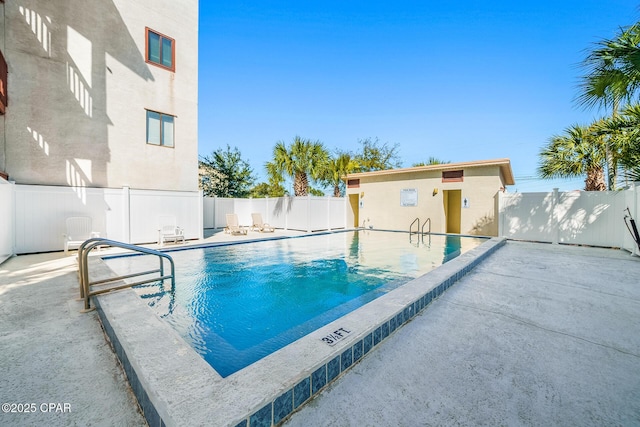 pool with a patio area and a fenced backyard