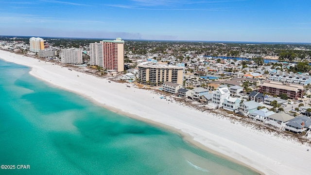 birds eye view of property featuring a water view, a view of city, and a beach view