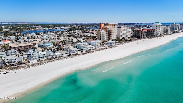 bird's eye view with a water view, a view of the beach, and a city view