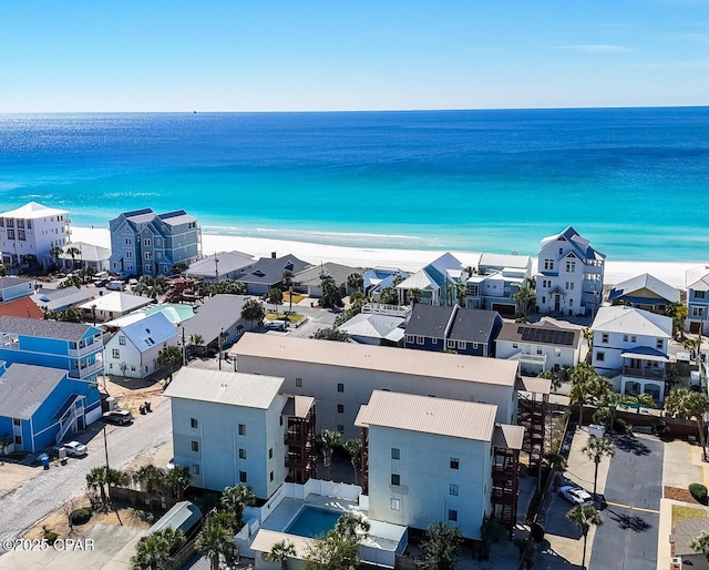 aerial view with a water view, a residential view, and a beach view
