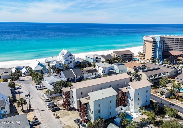 drone / aerial view featuring a water view and a view of the beach