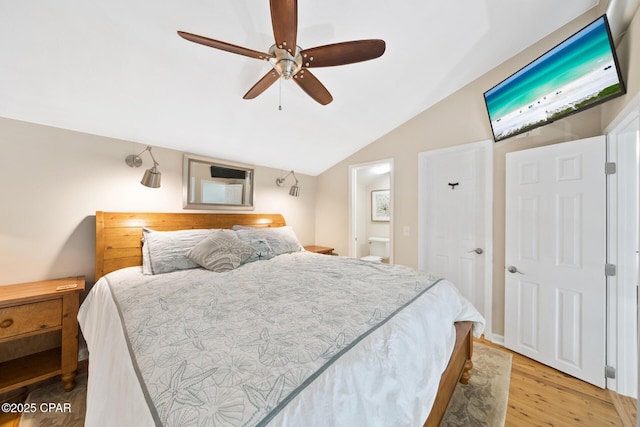 bedroom with light wood-style floors, vaulted ceiling, and a ceiling fan