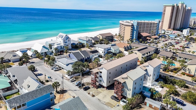 drone / aerial view featuring a beach view and a water view