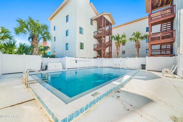 pool featuring fence and a patio