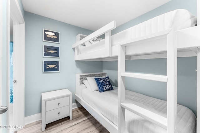 9860 S Thomas Dr Unit 1919, Panama City, FL 32408 - bedroom with wood finished floors and baseboards