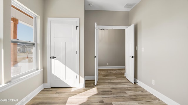 hall with light wood-type flooring