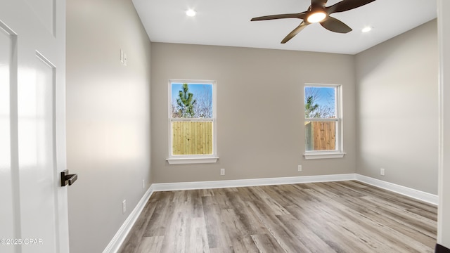 spare room featuring ceiling fan and light hardwood / wood-style floors