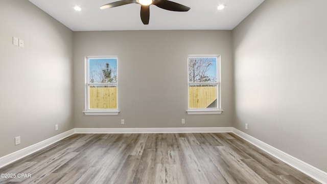 spare room featuring light hardwood / wood-style flooring and ceiling fan