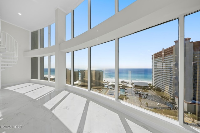 unfurnished sunroom featuring a water view