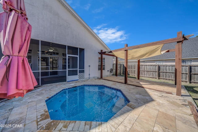 view of swimming pool featuring a patio area, a sunroom, and a fenced backyard