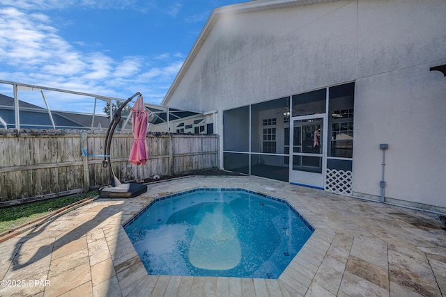 view of swimming pool with a patio, a fenced backyard, and a sunroom