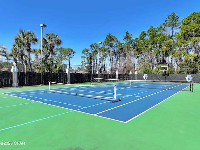 view of sport court featuring community basketball court and fence