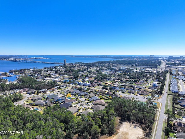 drone / aerial view with a water view and a residential view