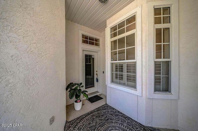 entrance to property with stucco siding