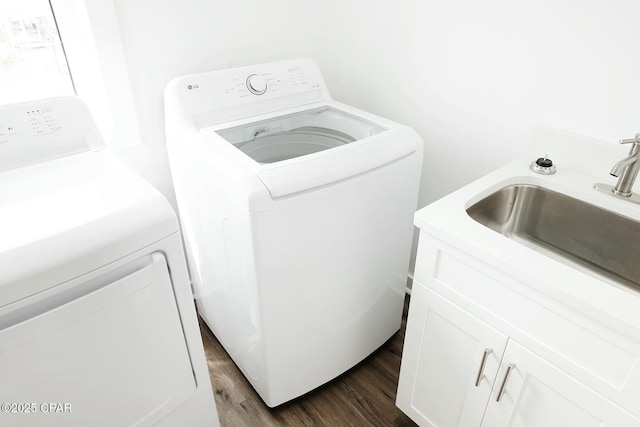 4112 Snapper St, Panama City Beach, FL 32408 - clothes washing area with washer and clothes dryer, cabinet space, a sink, and dark wood-style floors