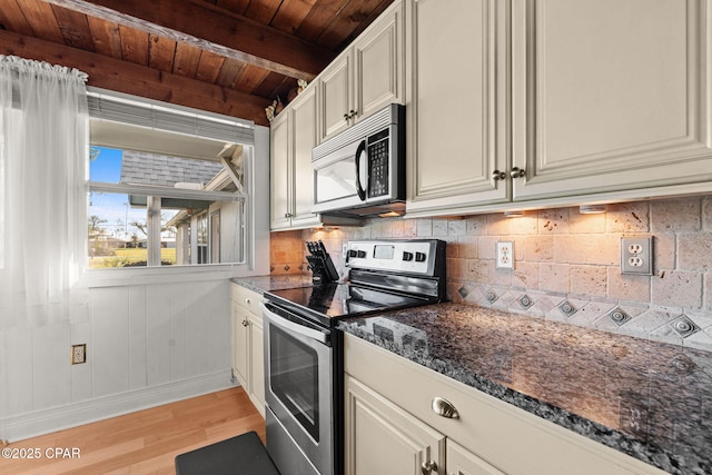 7331 Resota Ln, Southport, FL 32409 - kitchen with stainless steel appliances, light wood-type flooring, decorative backsplash, wood ceiling with exposed beams, and dark stone counters