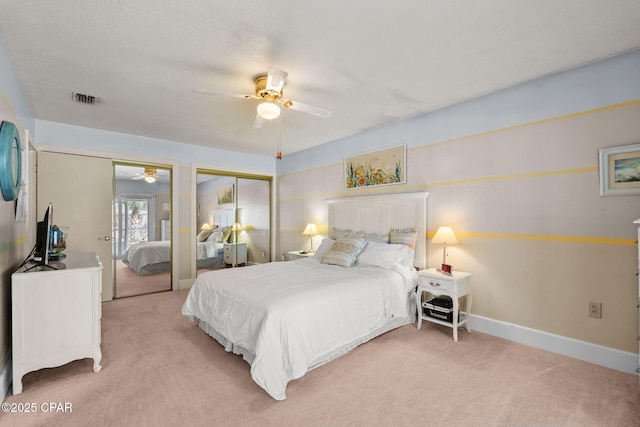 7331 Resota Ln, Southport, FL 32409 - bedroom with light colored carpet, two closets, baseboards, and ceiling fan