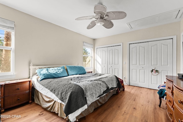 7331 Resota Ln, Southport, FL 32409 - bedroom with attic access, two closets, multiple windows, and light wood-style flooring