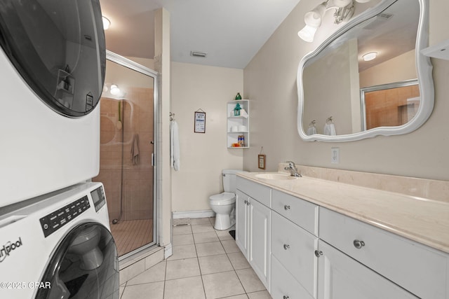 7331 Resota Ln, Southport, FL 32409 - full bathroom with stacked washing machine and dryer, vanity, toilet, a shower stall, and tile patterned flooring