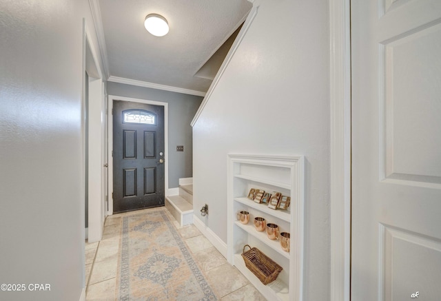 foyer featuring crown molding, light tile patterned floors, and baseboards