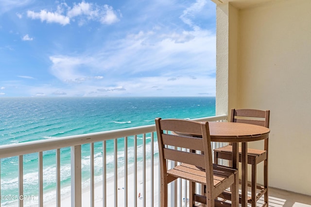 balcony with a view of the beach and a water view