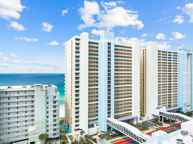 view of building exterior with a water view and a view of city