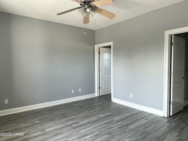 unfurnished bedroom featuring dark wood-style floors, ceiling fan, a textured ceiling, and baseboards