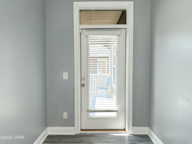 entryway with baseboards and dark wood finished floors