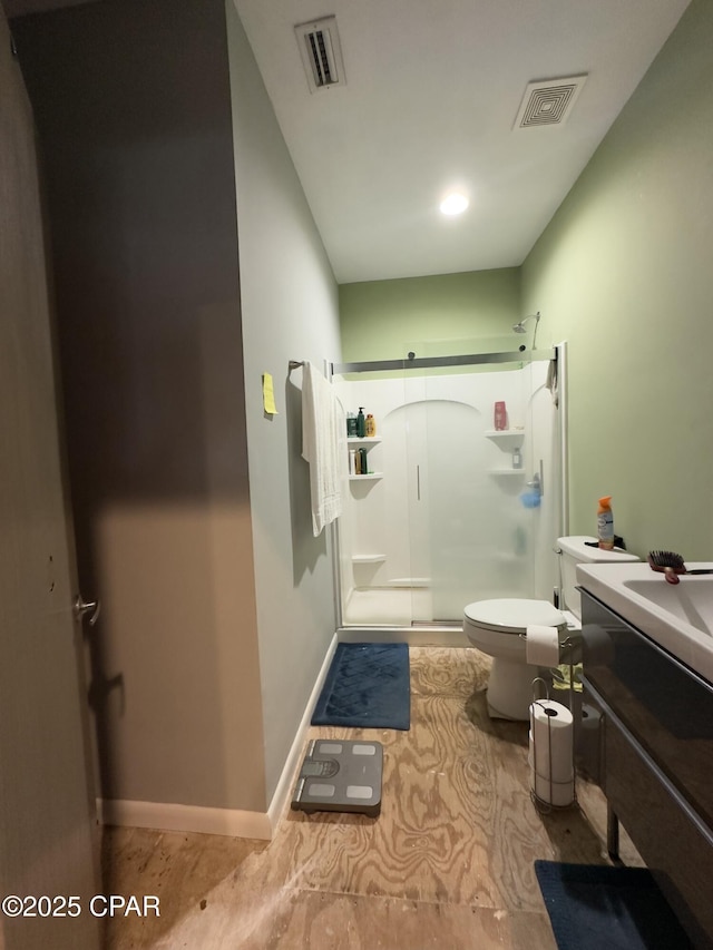 bathroom featuring a stall shower, vanity, visible vents, and baseboards