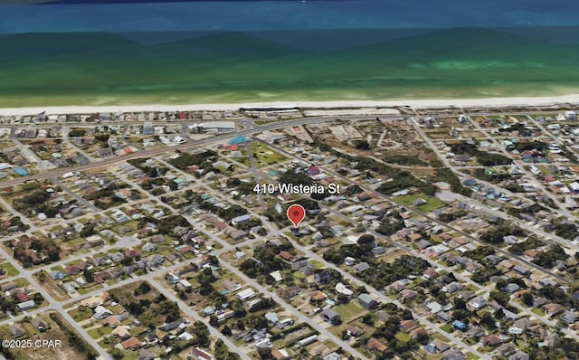 bird's eye view featuring a view of the beach, a water view, and a residential view