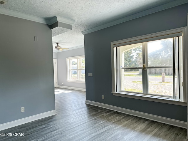 unfurnished room with baseboards, dark wood finished floors, ceiling fan, ornamental molding, and a textured ceiling