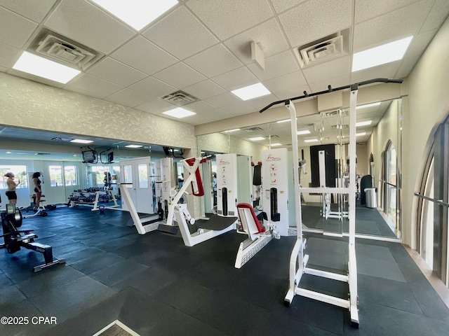 gym with a paneled ceiling