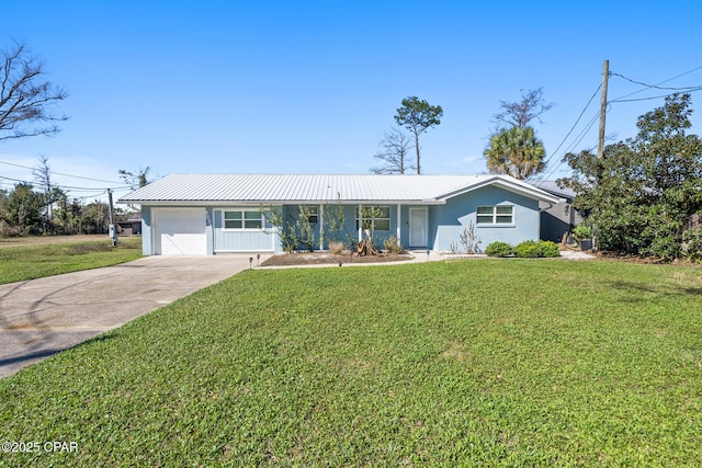 view of front facade featuring metal roof, concrete driveway, and a front lawn