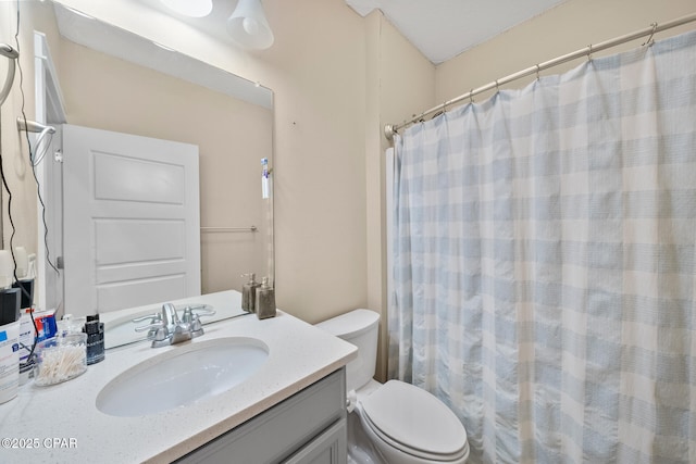 bathroom with toilet, a shower with shower curtain, and vanity