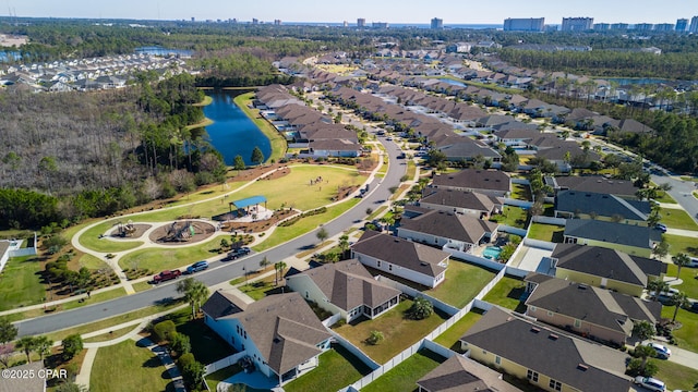 drone / aerial view featuring a residential view and a water view