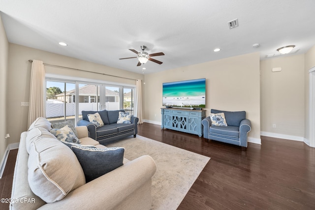 living area with dark wood-style floors, recessed lighting, visible vents, and baseboards